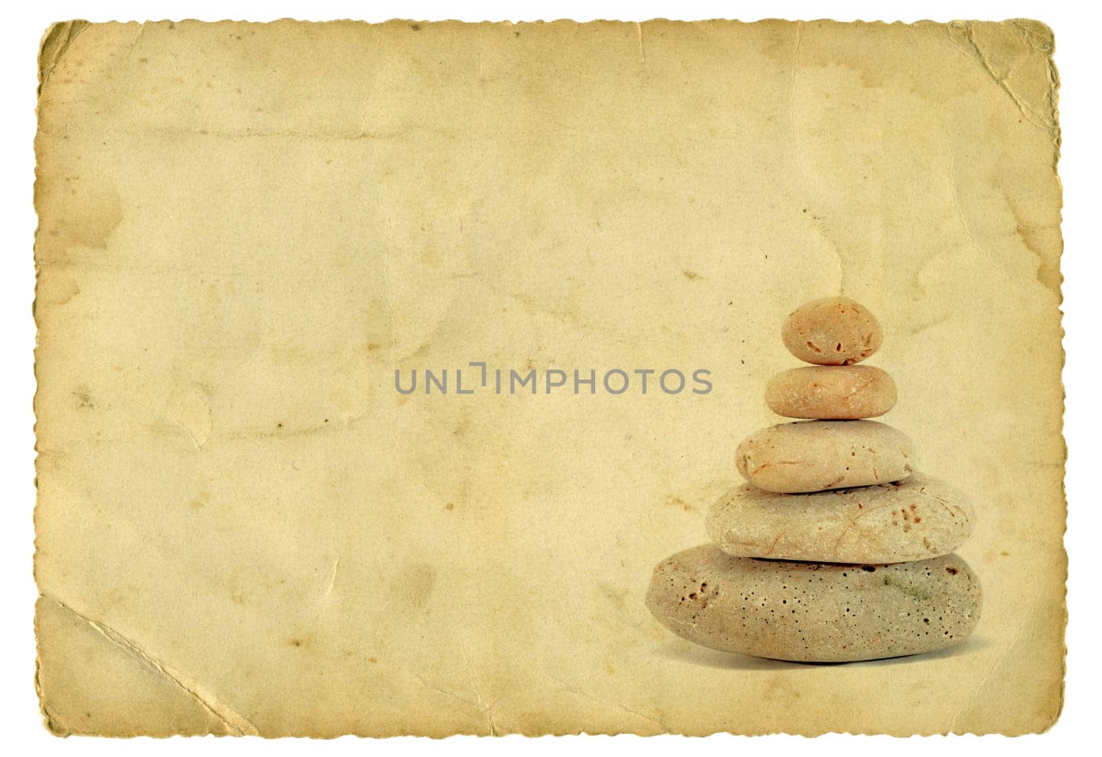 Stack of stones on old paper background