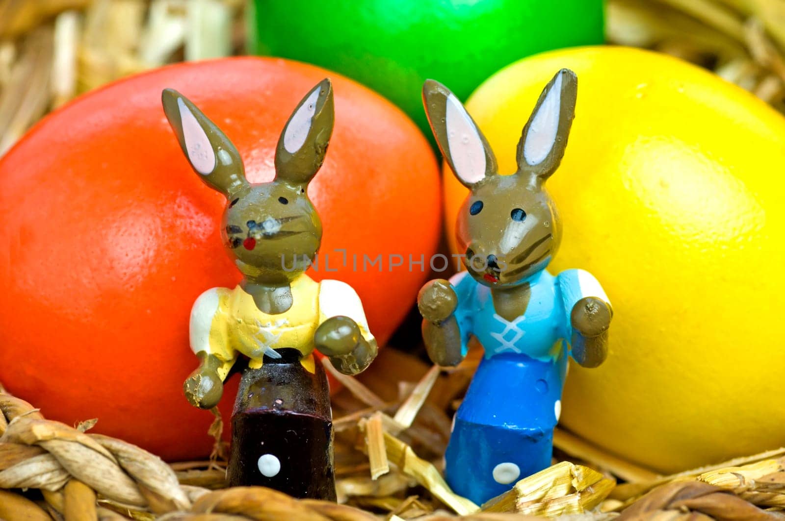 Easter basket with colorful eggs and Easter bunnies