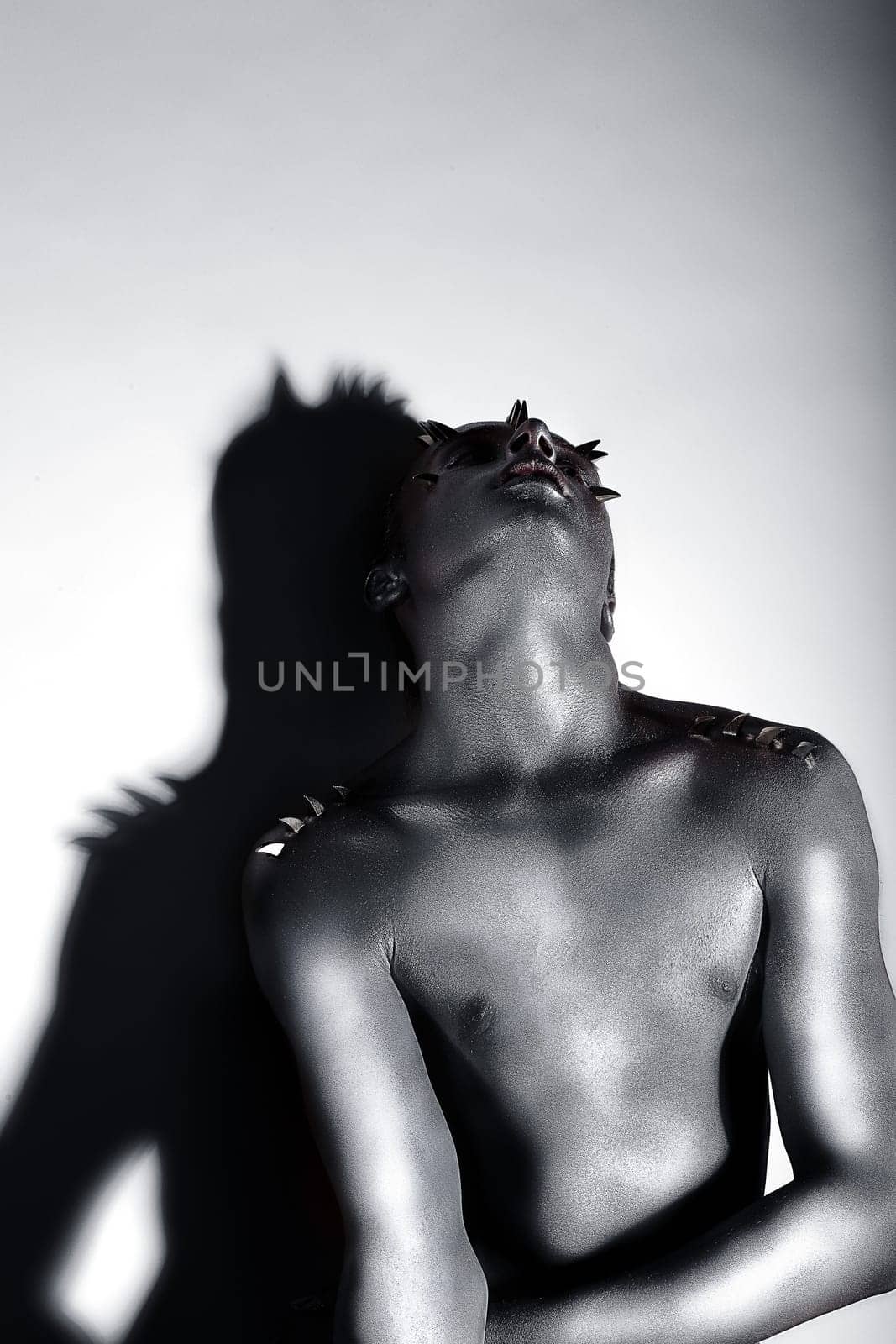 Expressive Emotions. Drama. Silver-plated Man posing. Creativity