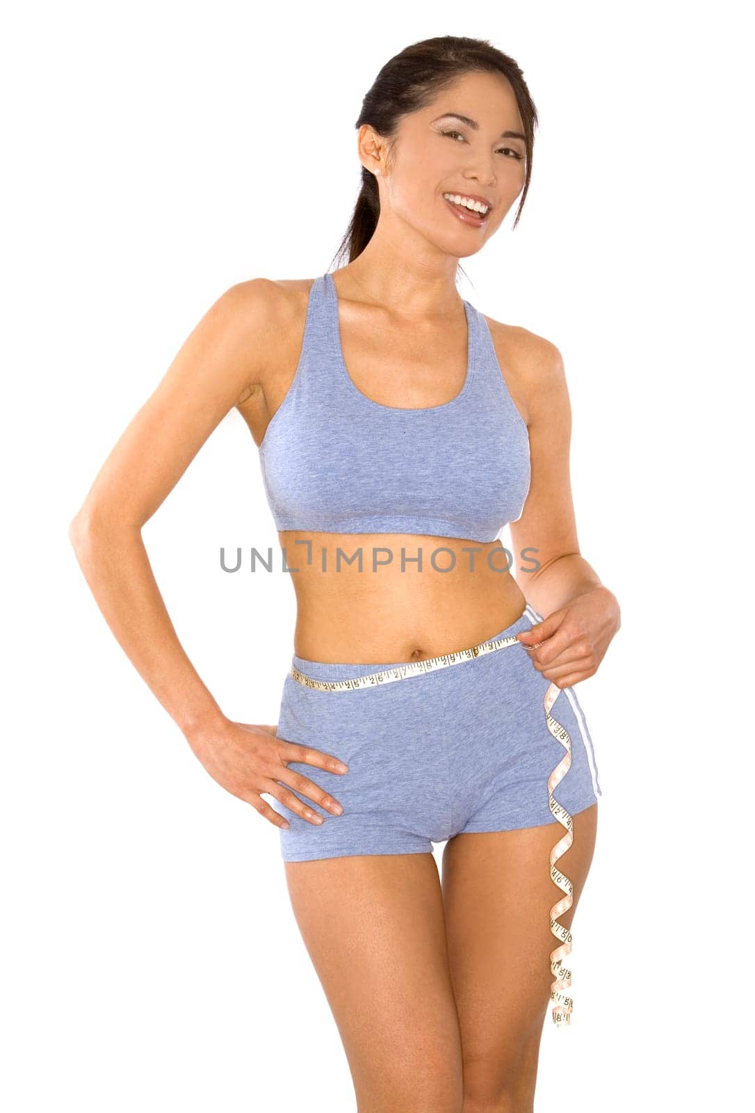 pretty asian woman measuring her waist line