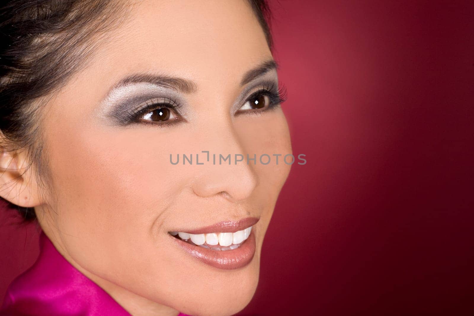 pretty asian woman wearing dark makeup on red