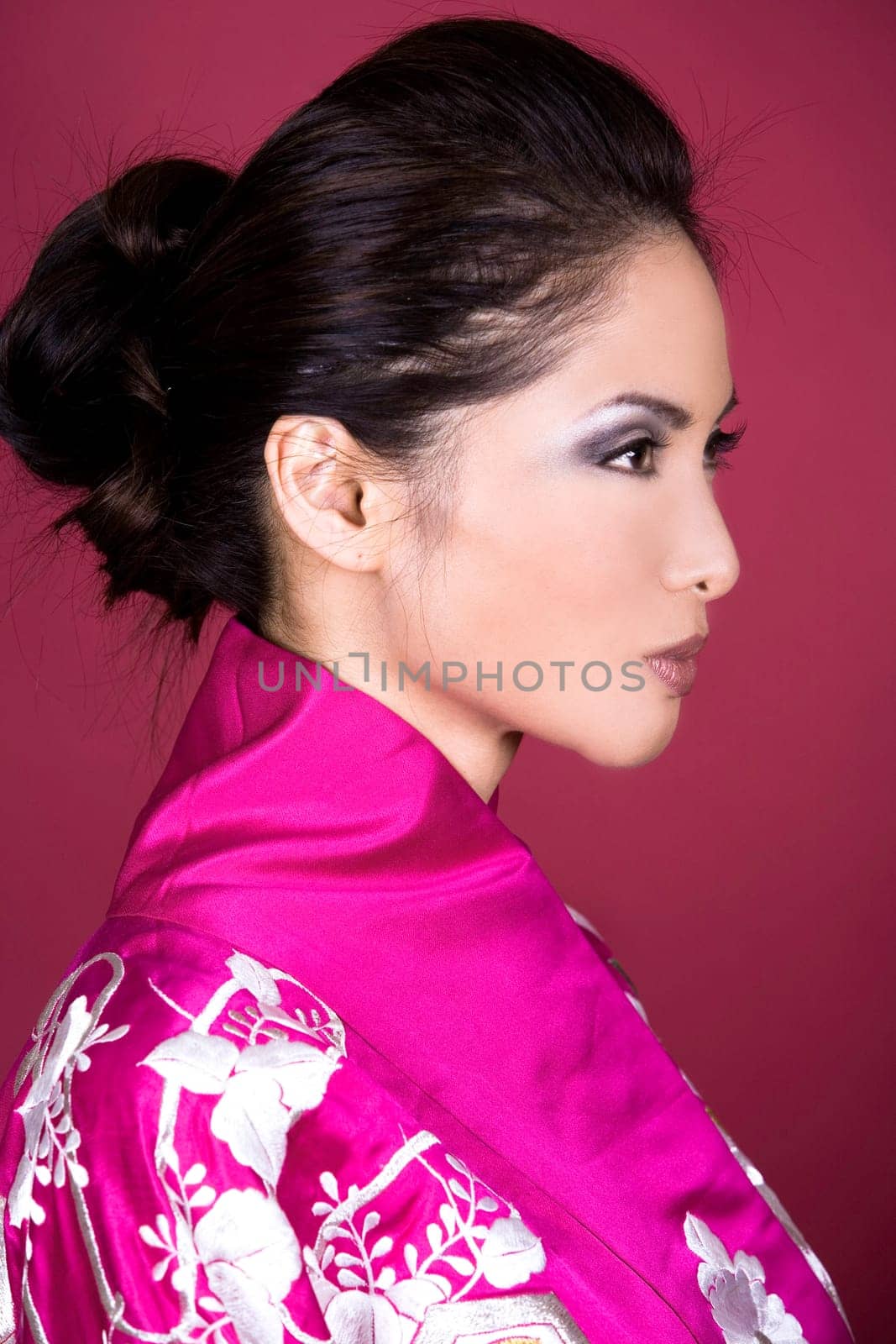 pretty asian woman wearing kimono on red background