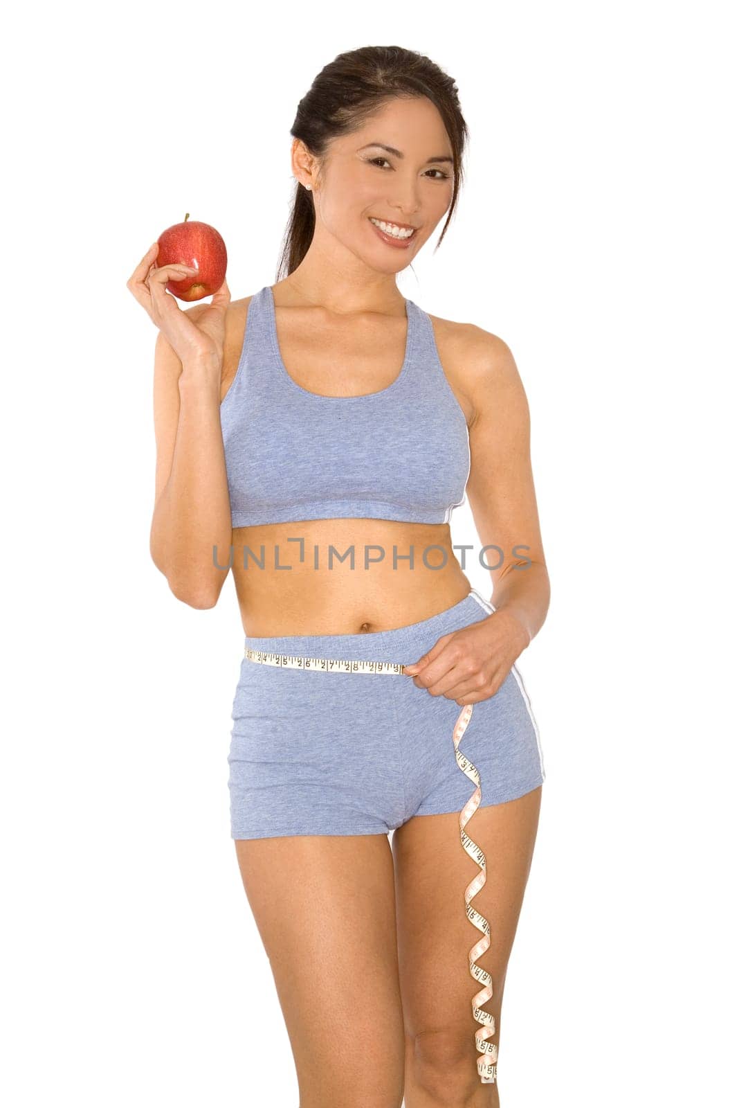 pretty asian woman measuring her waist line