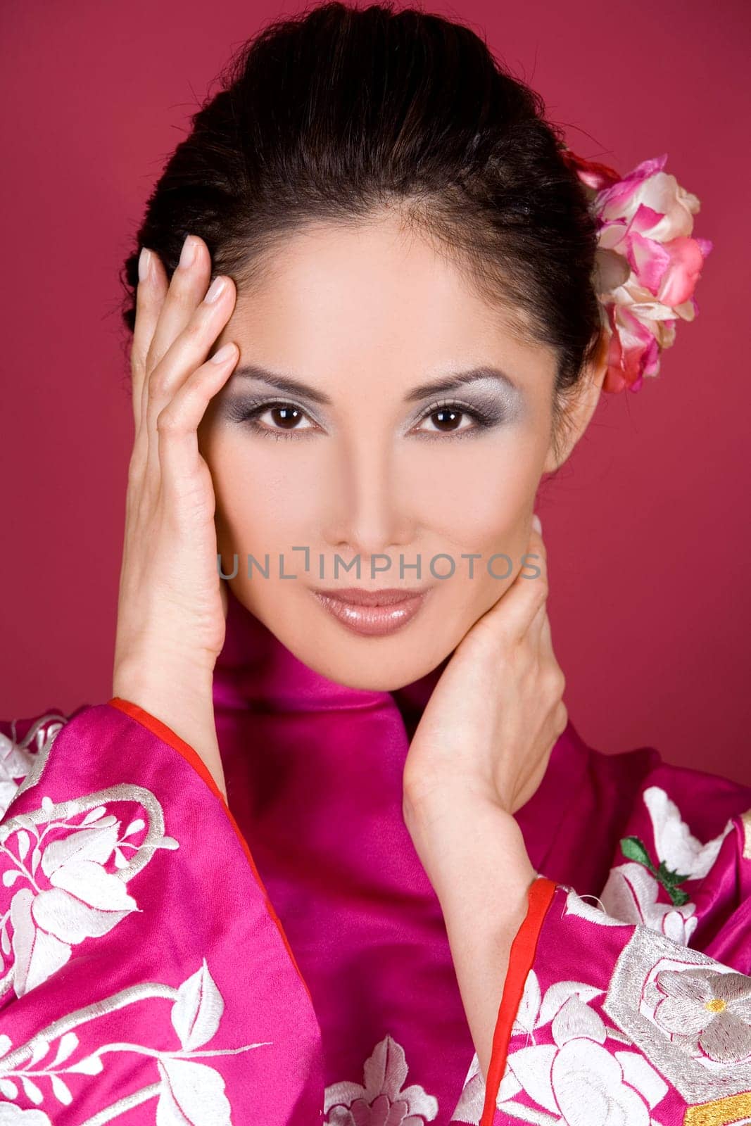pretty asian woman wearing kimono on red background