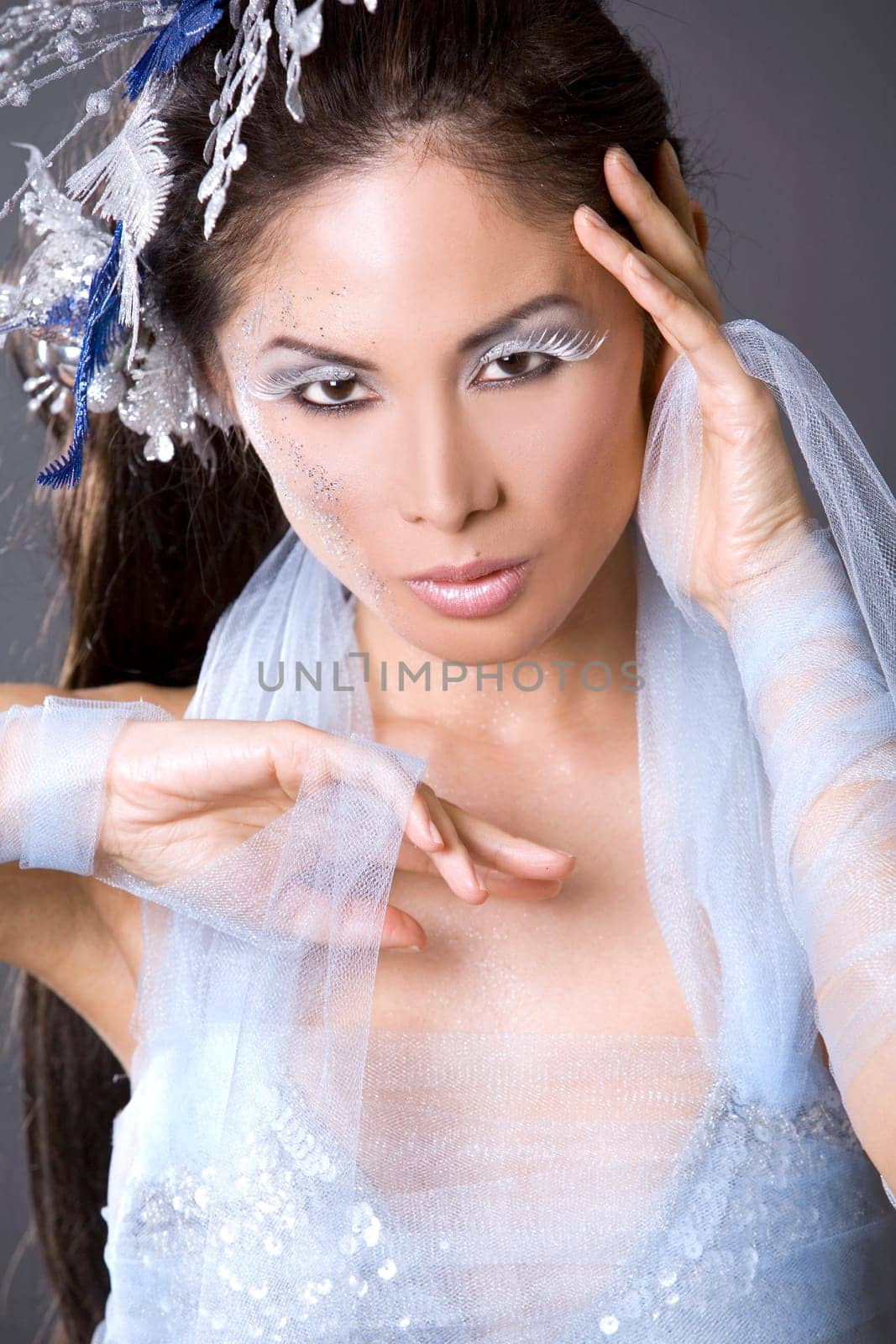pretty brunette woman wearing white and silver accessories