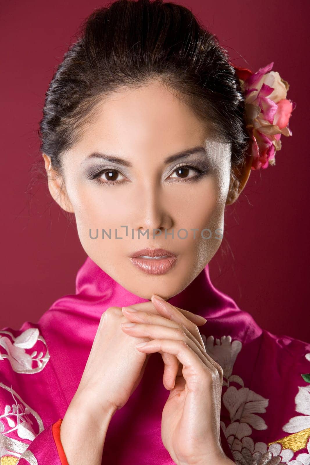 pretty asian woman wearing kimono on red background