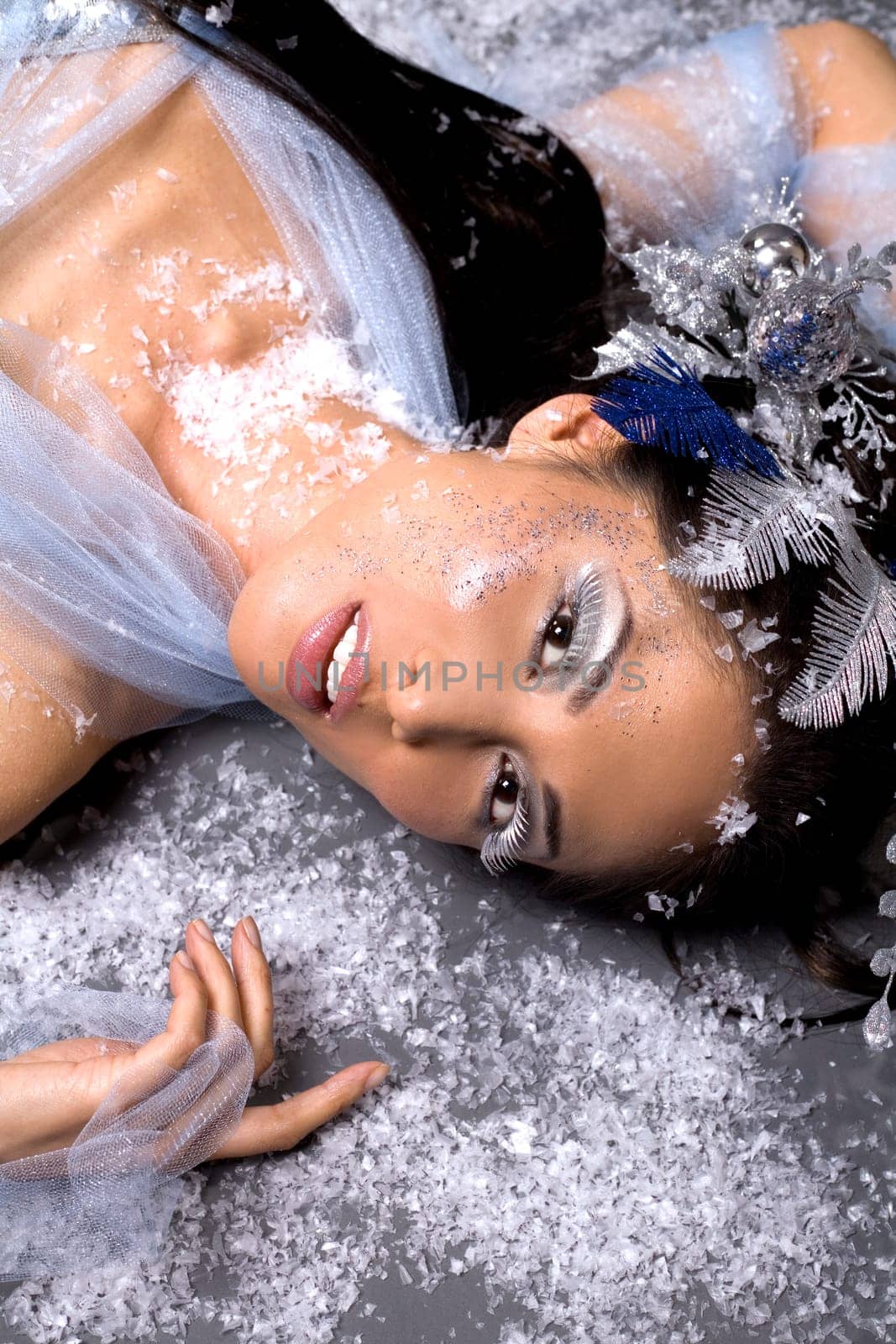 pretty brunette woman wearing white and silver accessories