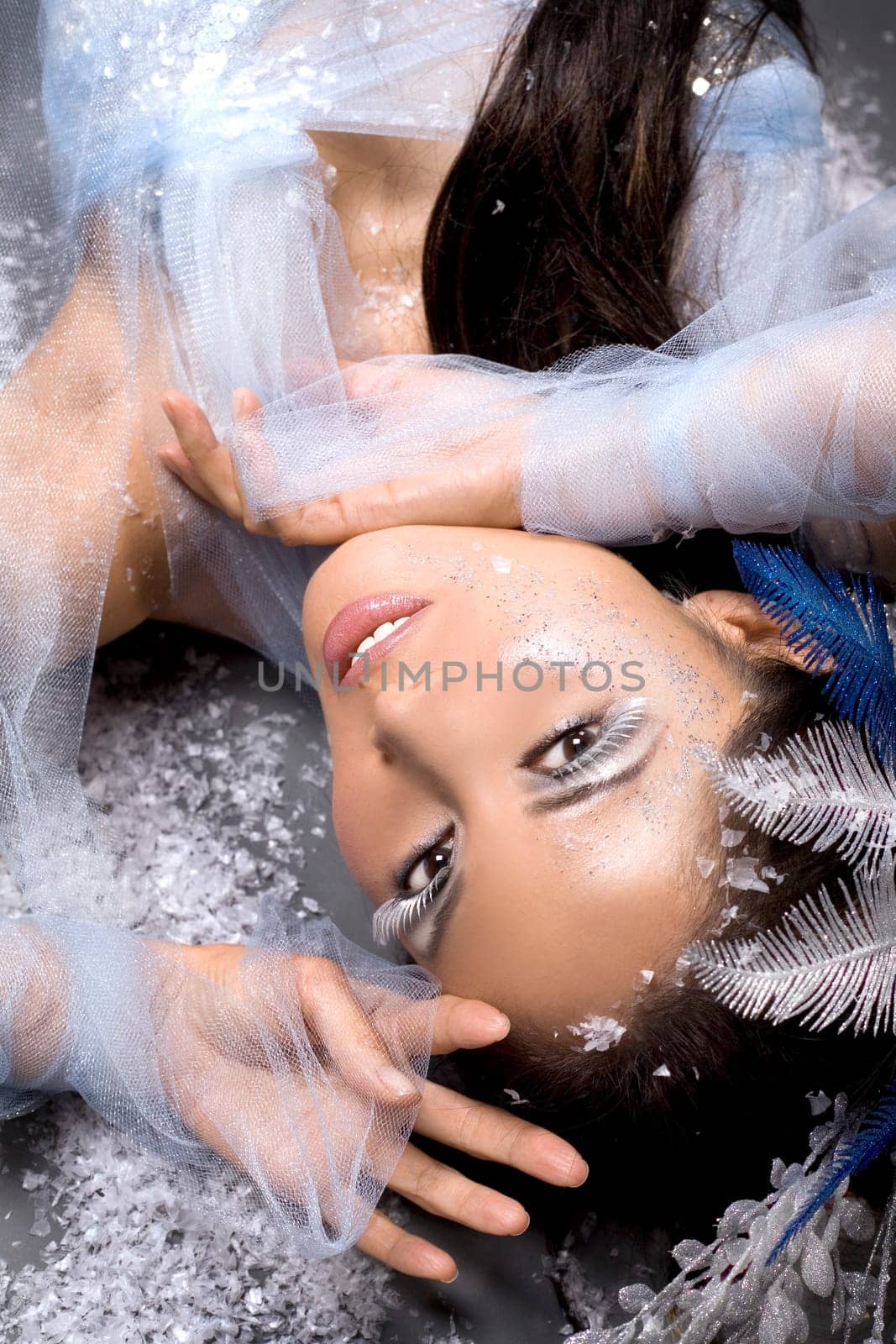 pretty brunette woman wearing white and silver accessories