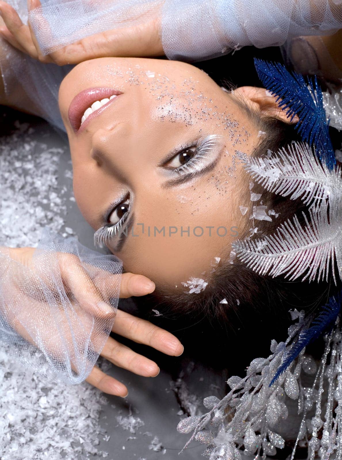 pretty brunette woman wearing white and silver accessories