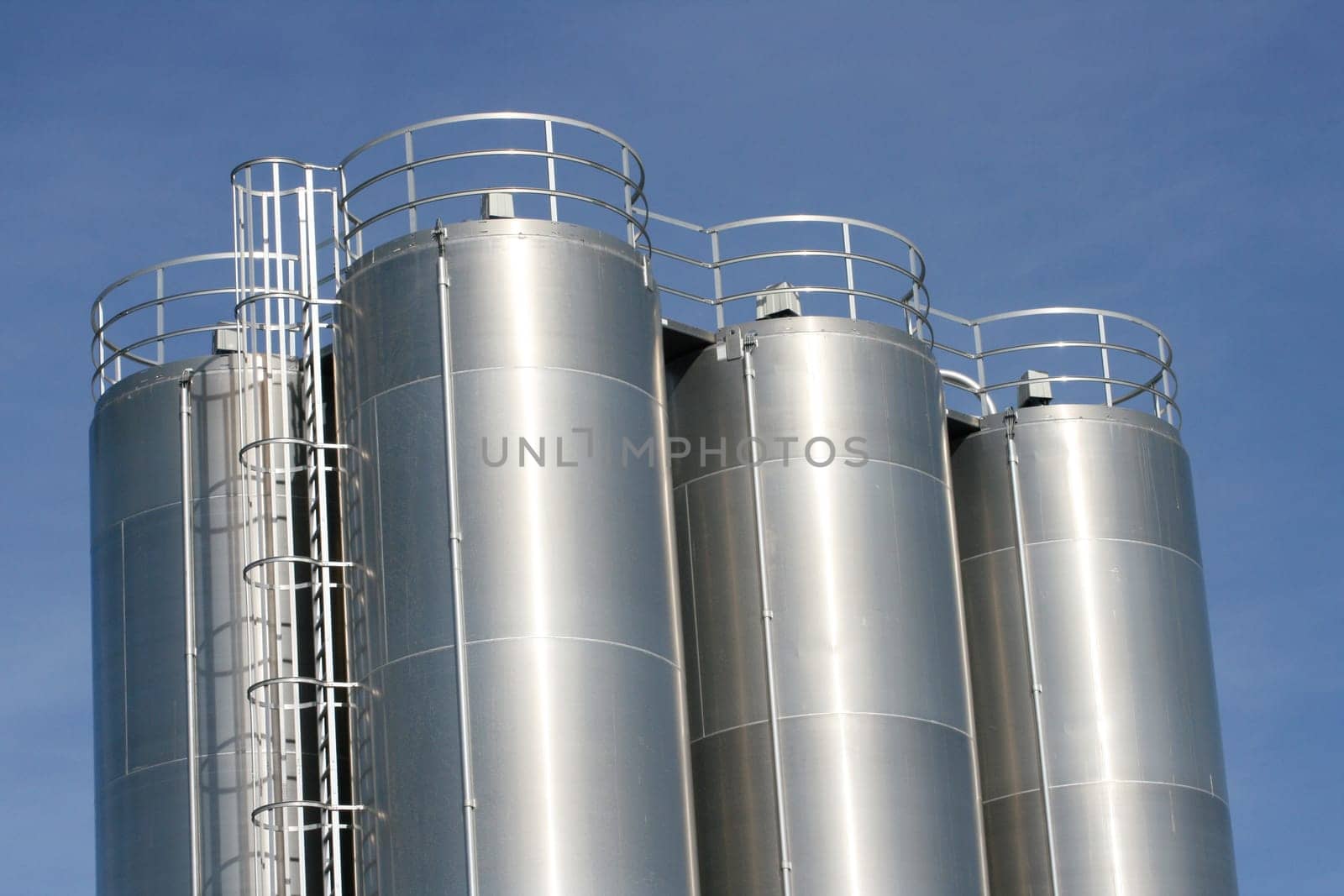 View of an industrial plant with large aluminium tanks