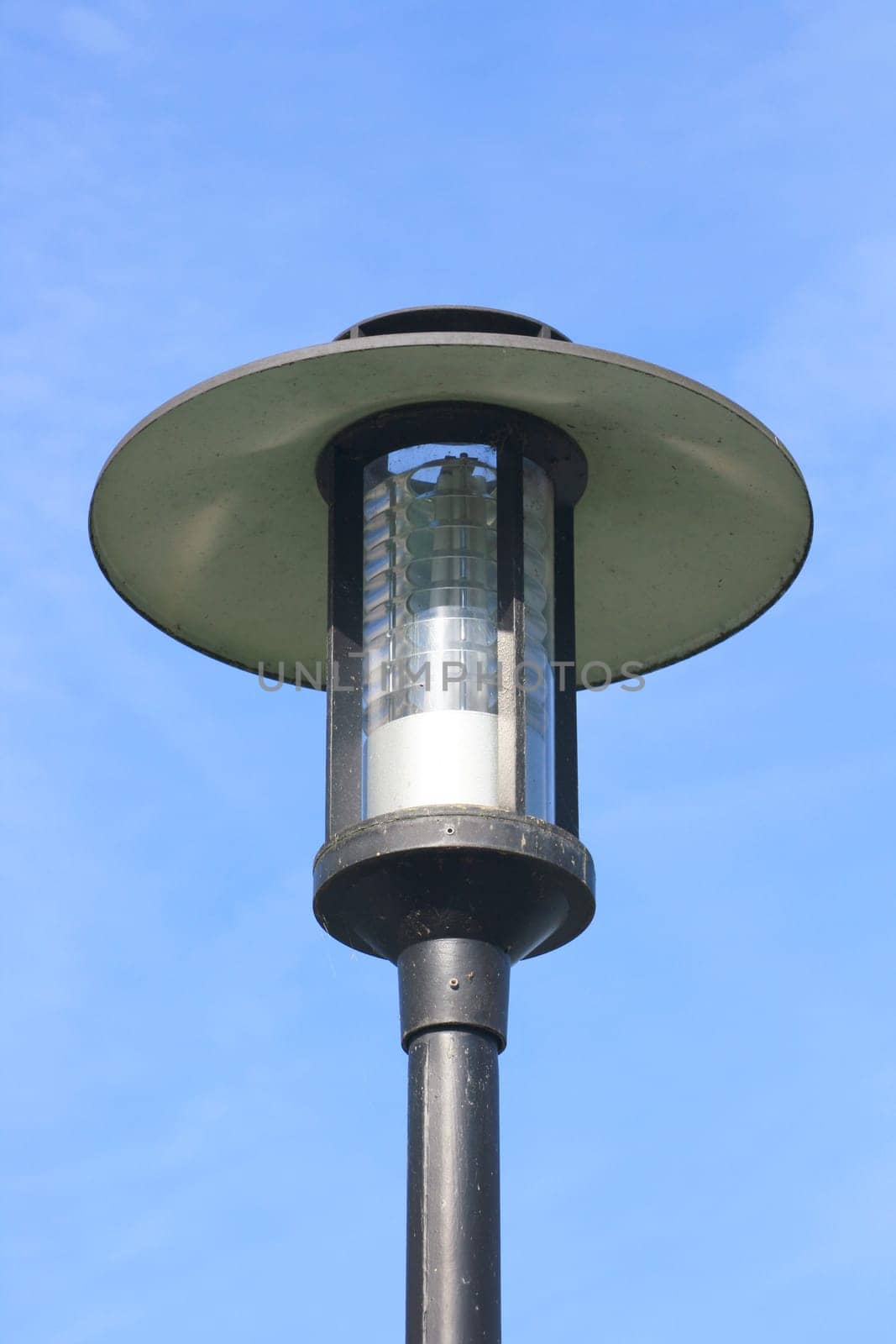 Street lamp with large umbrella,blue sky in the background