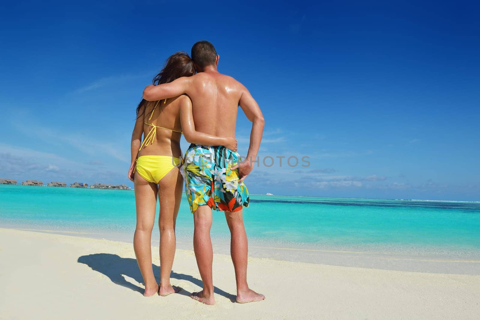 happy young asian couple enjoying summer and have on beautiful white sand beach