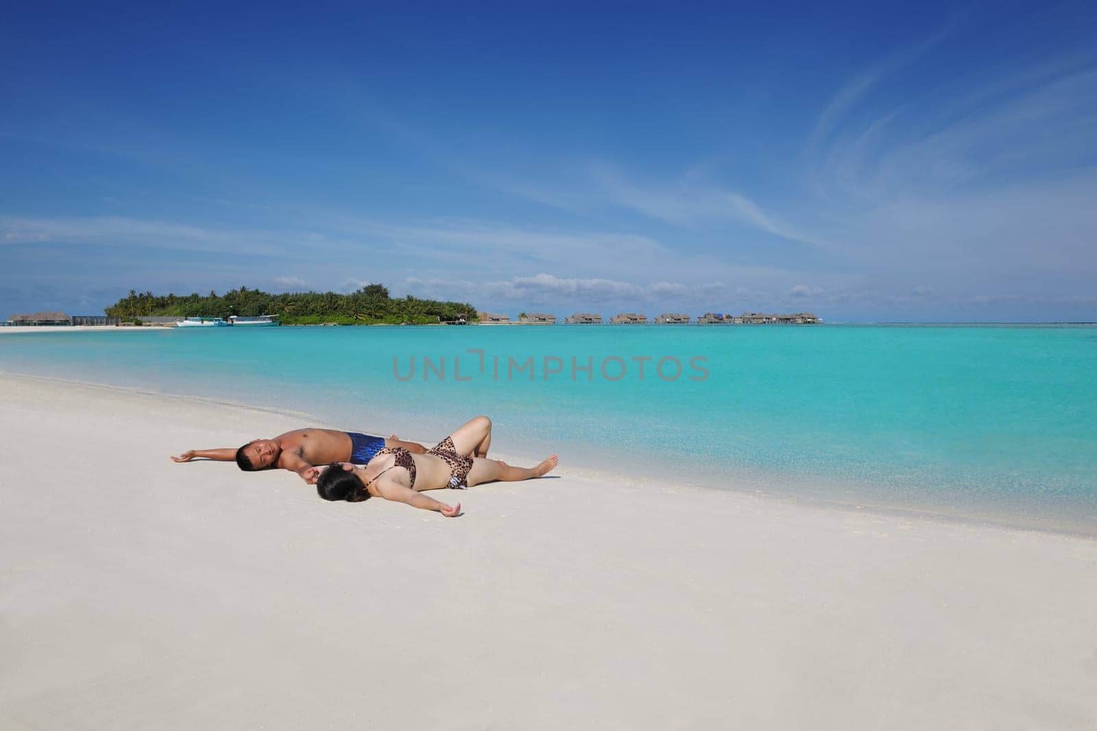 happy young asian couple enjoying summer and have on beautiful white sand beach