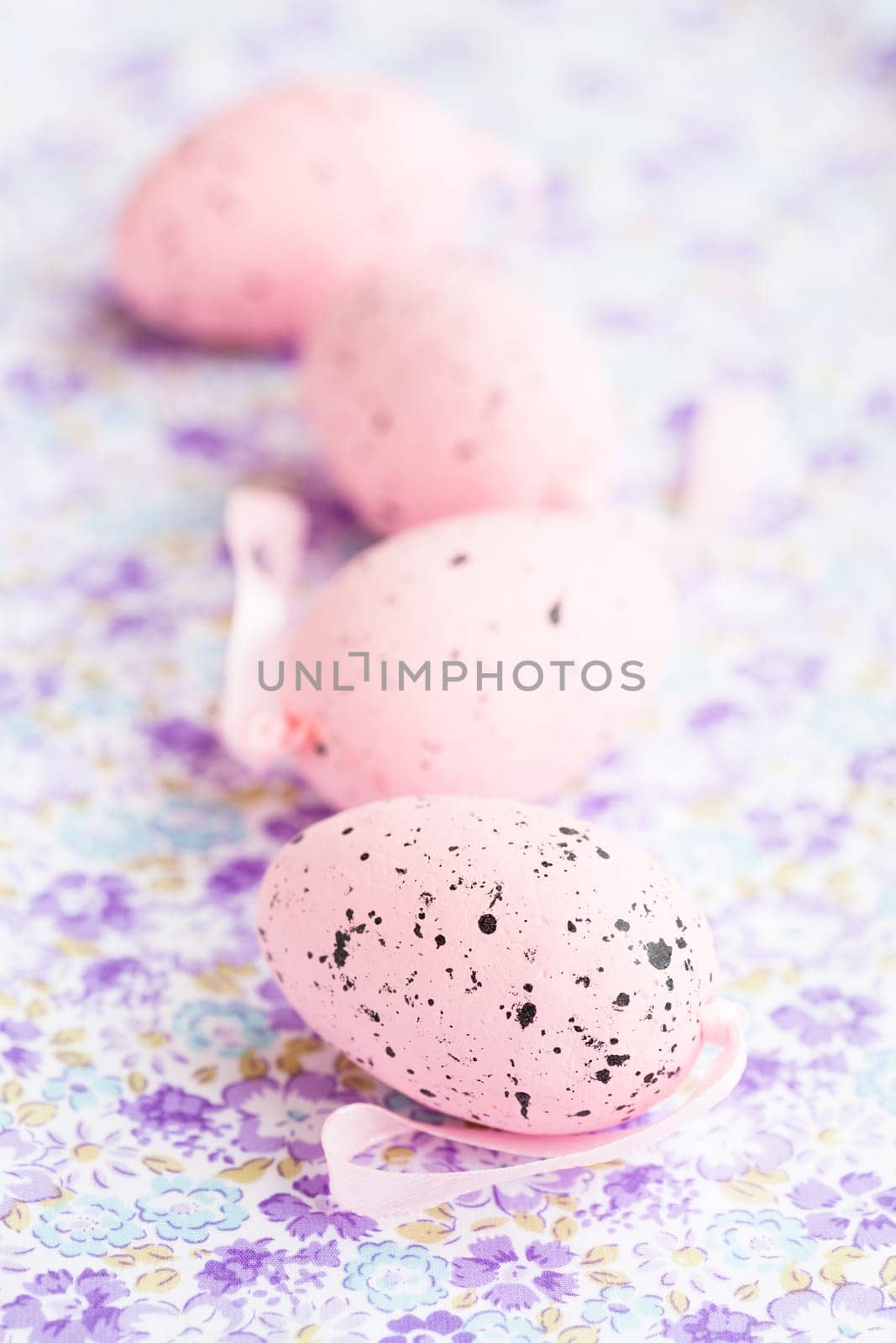 Closeup of pink Easter eggs on patterned surface