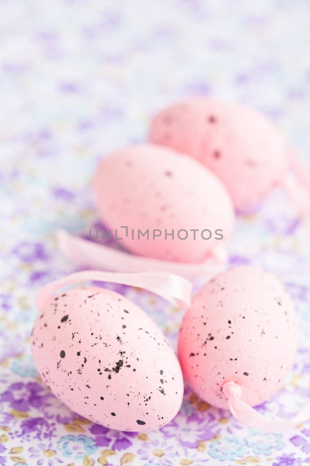Closeup of pink Easter eggs on patterned surface