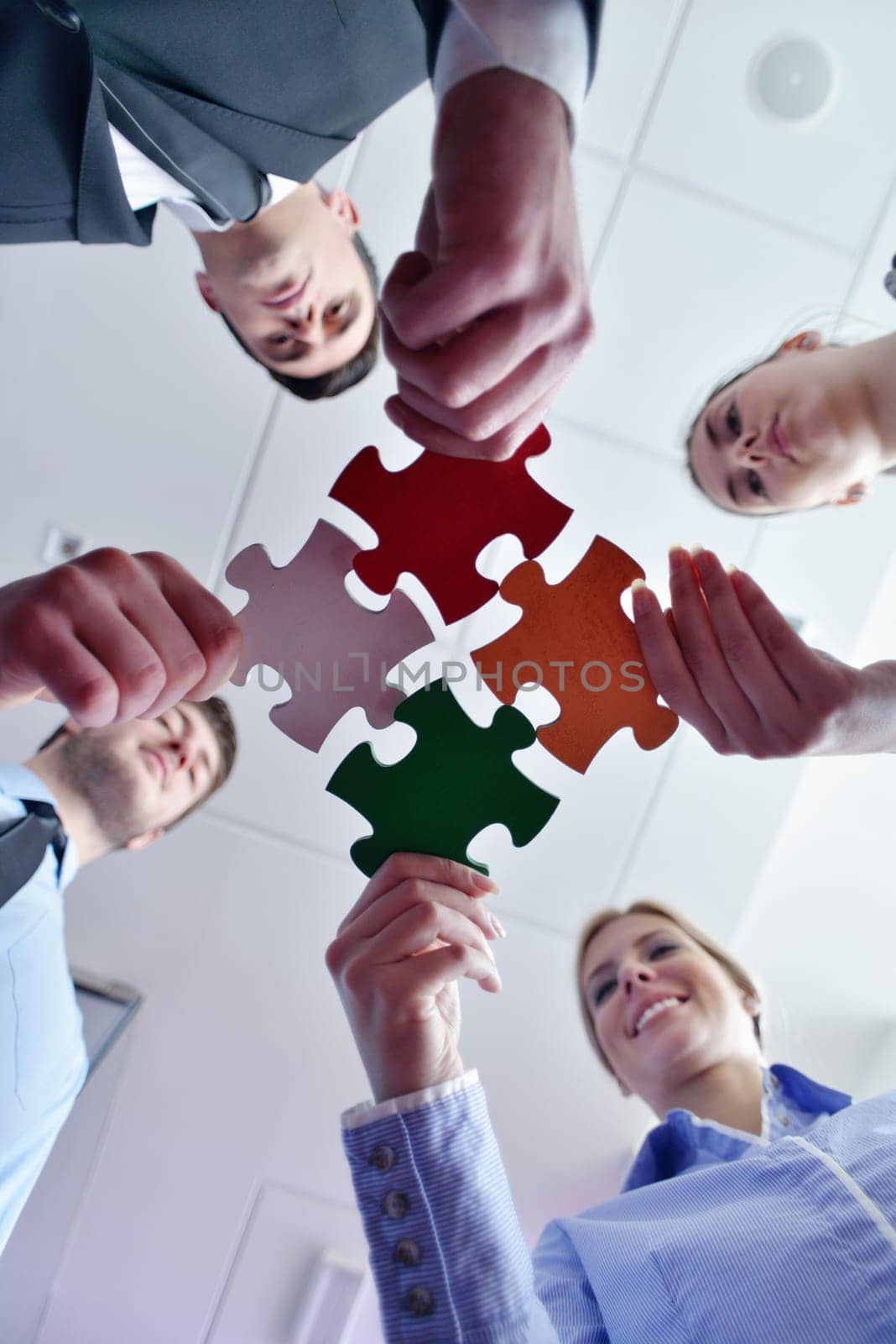 Group of business people assembling jigsaw puzzle and represent team support and help concept