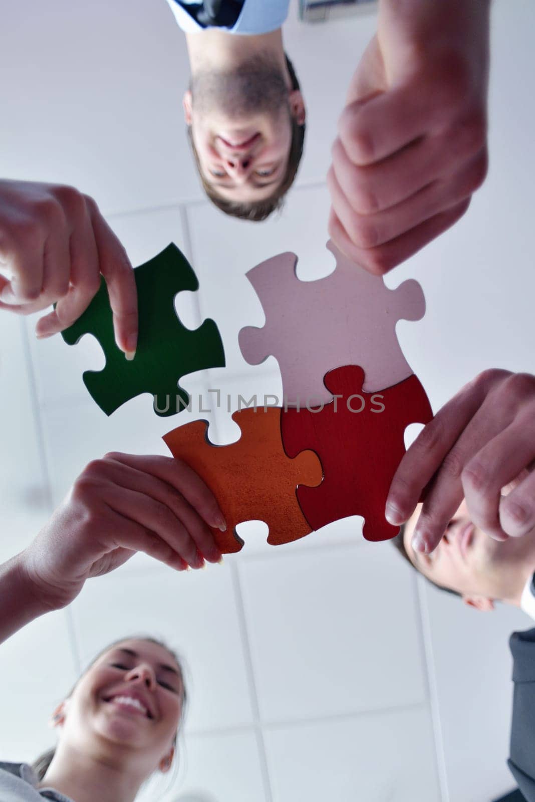 Group of business people assembling jigsaw puzzle and represent team support and help concept