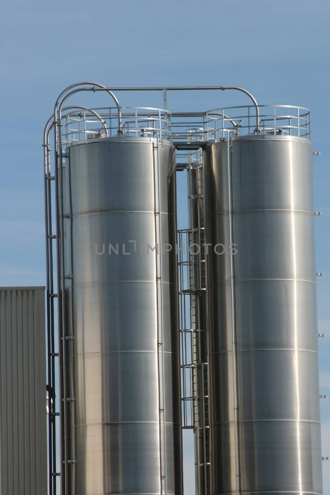 View of an industrial plant with large aluminium tanks