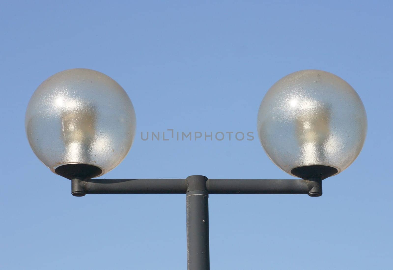a two-beam street lamp with large,spherical glass bodies