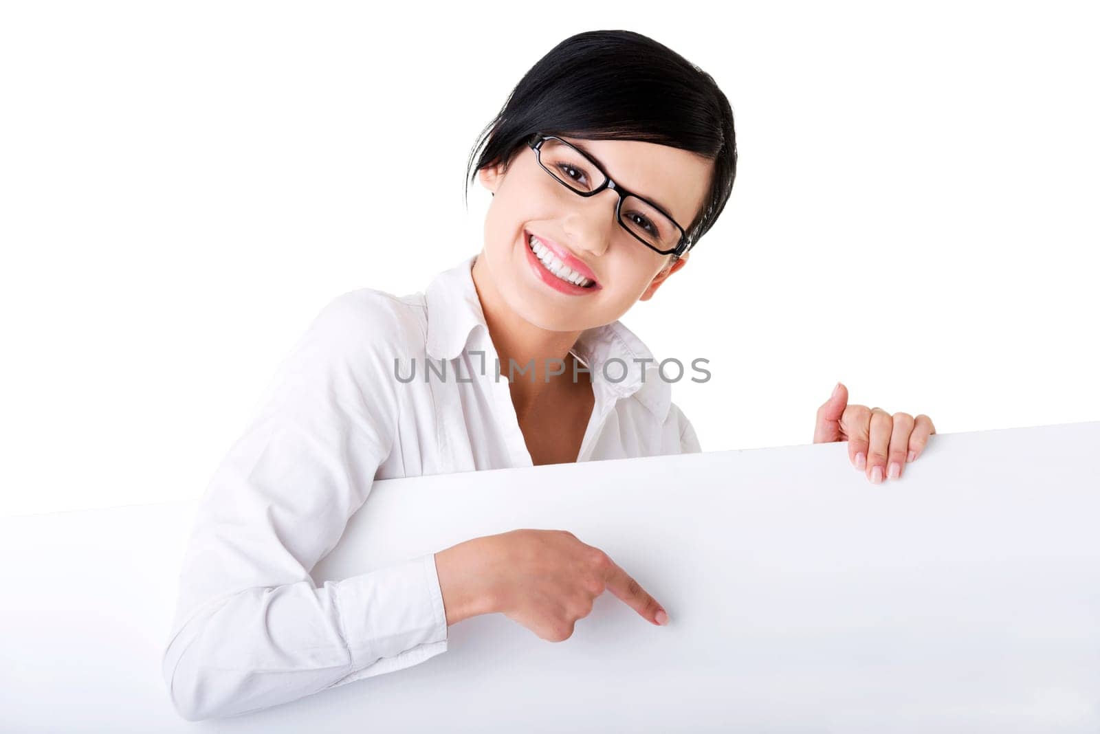 Smiling young business woman showing blank signboard, over white background isolated