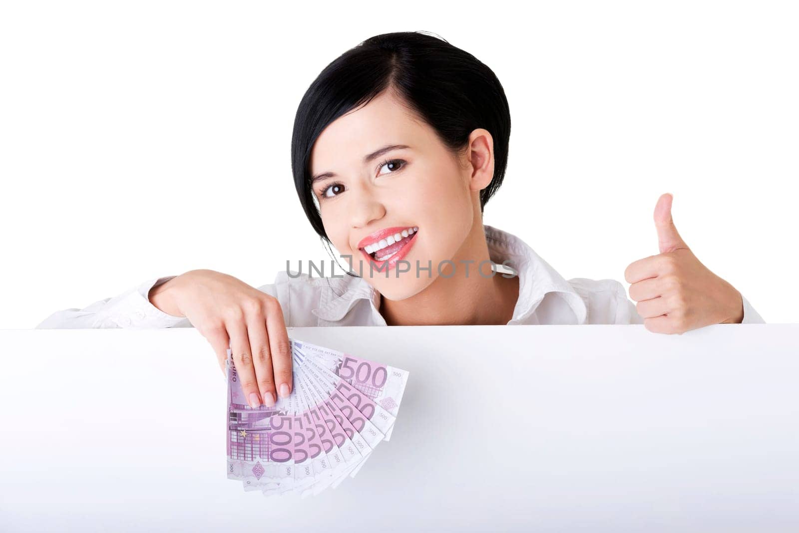 Business woman with blank sign board holding euro money and gesturing thumbs up.
