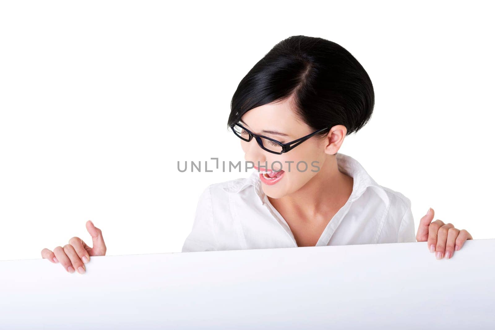 Smiling young business woman showing blank signboard, over white background isolated