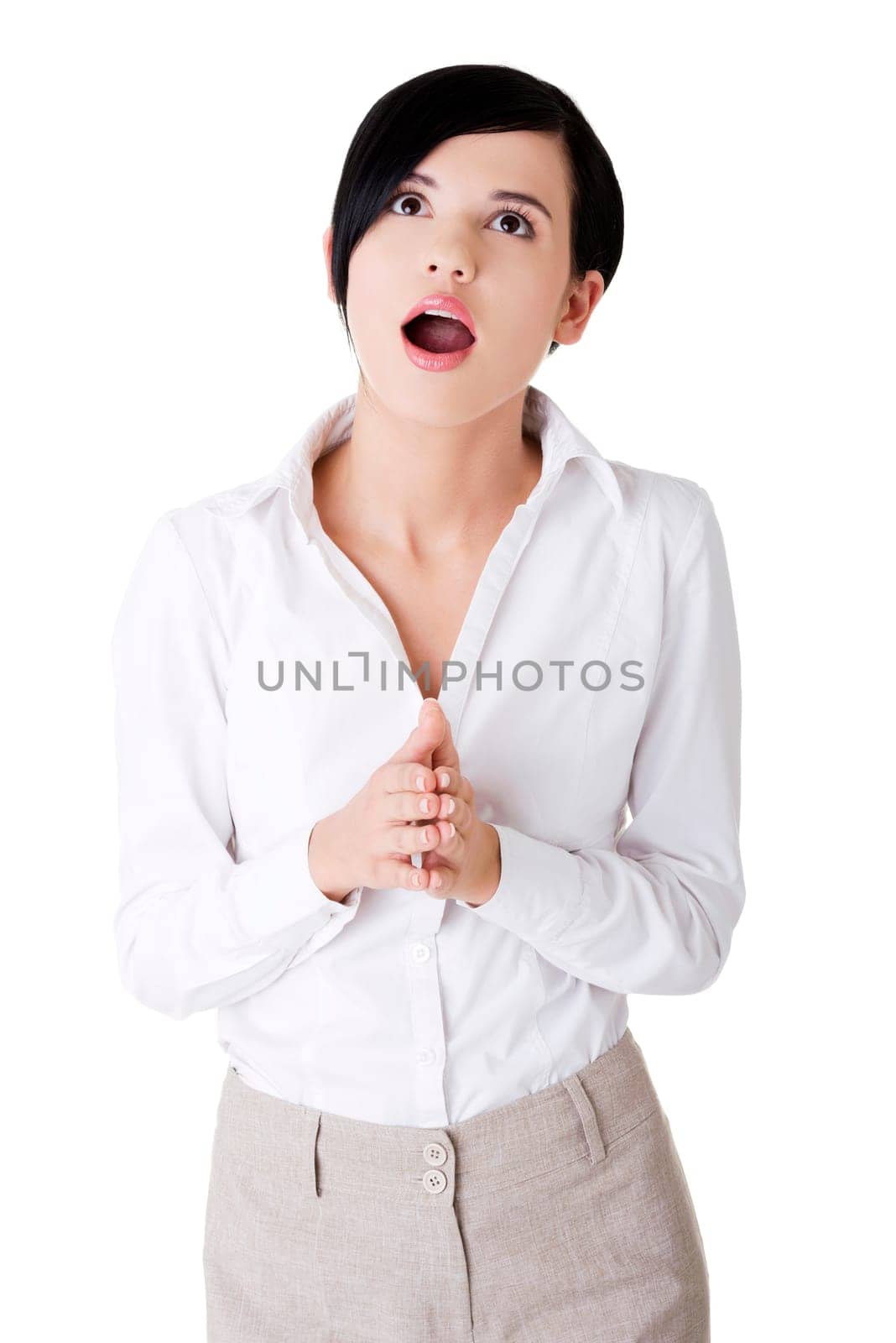 Shocked businesswoman looking up, isolated on white