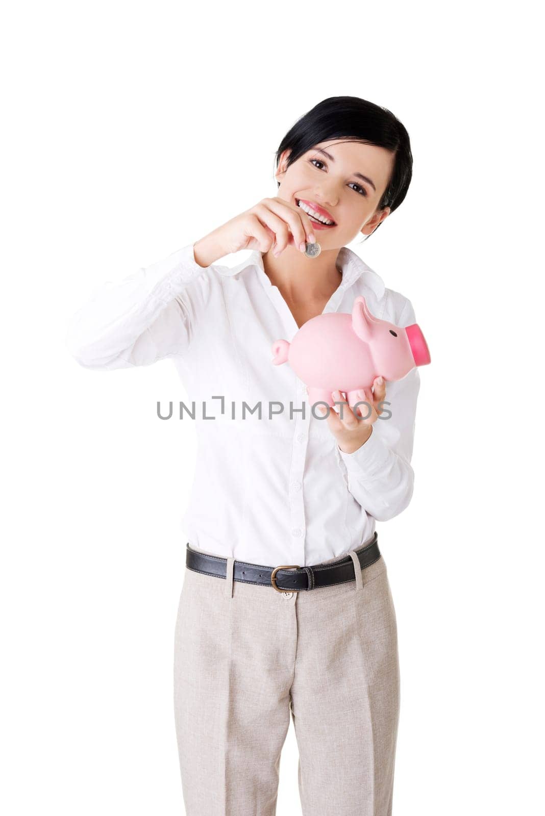 Happy businesswoman putting an euro coin into a piggy bank isolated on white background