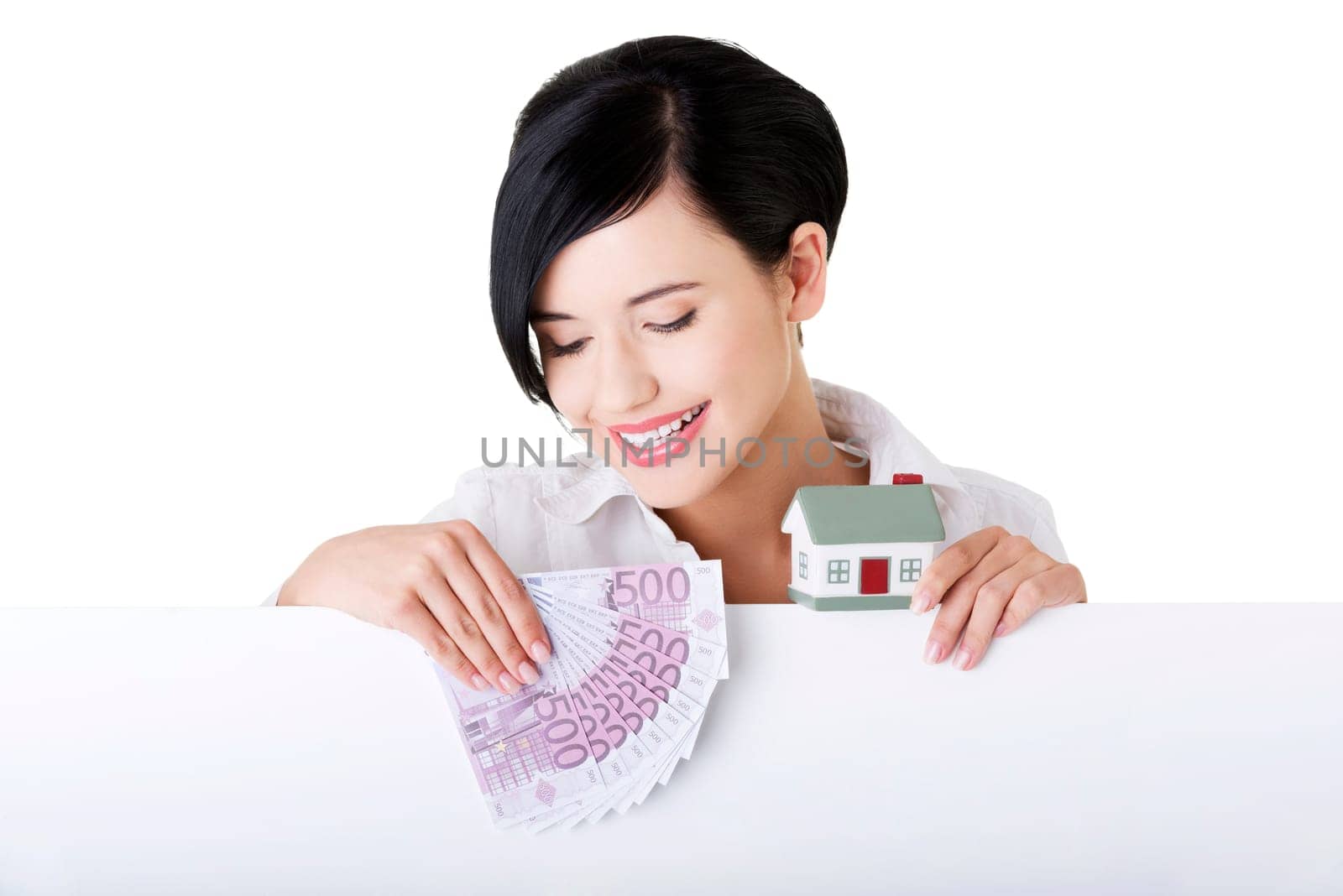 Business woman with blank sign board holding house model and euro money. Real estate loan concept