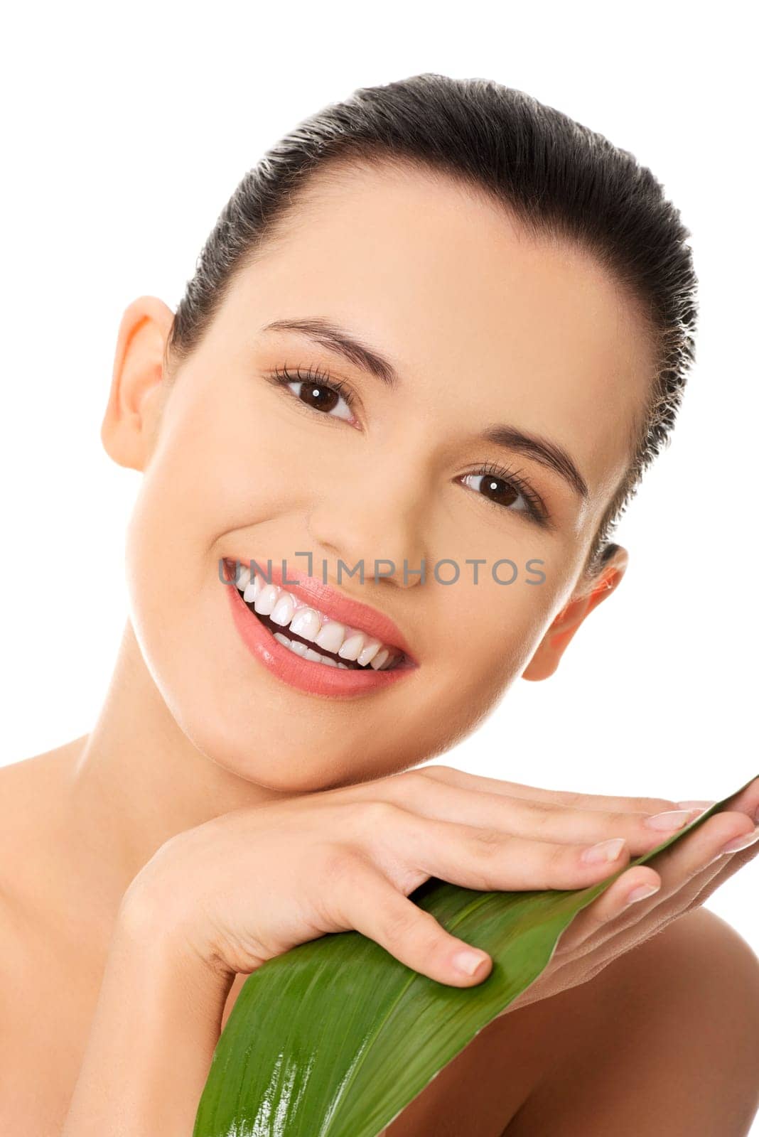 Portrait of young beautiful woman with green leaf , isolated