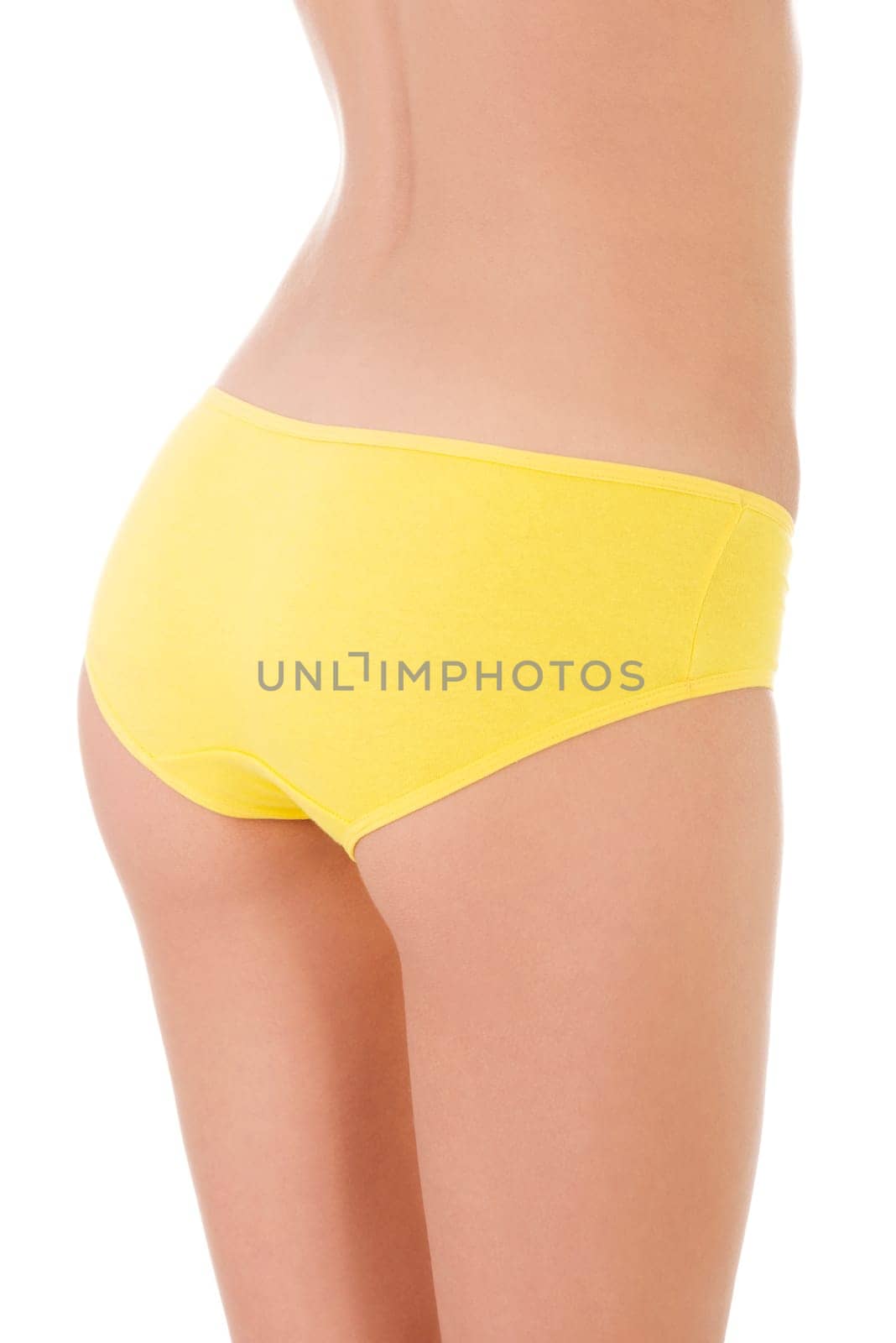 Slim tanned woman's body in yellow panties. Isolated over white background.