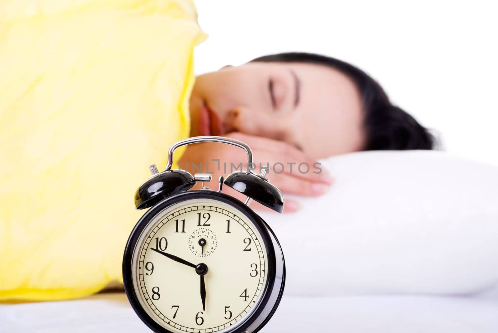 Alarm clock being placed on a nightstand in a bedroom