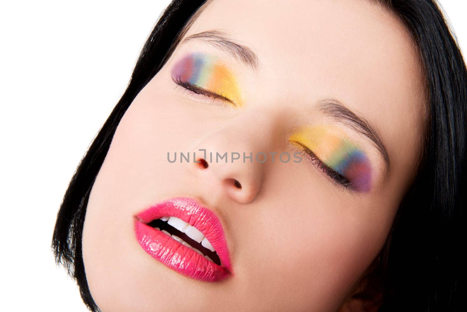 Beautiful woman with rainbow eye make up, isolated on white