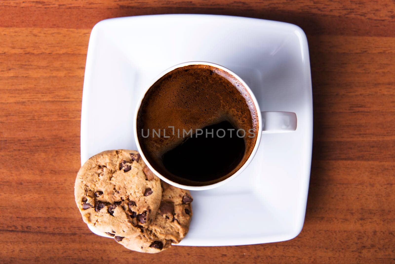 Coffee with cookie on table