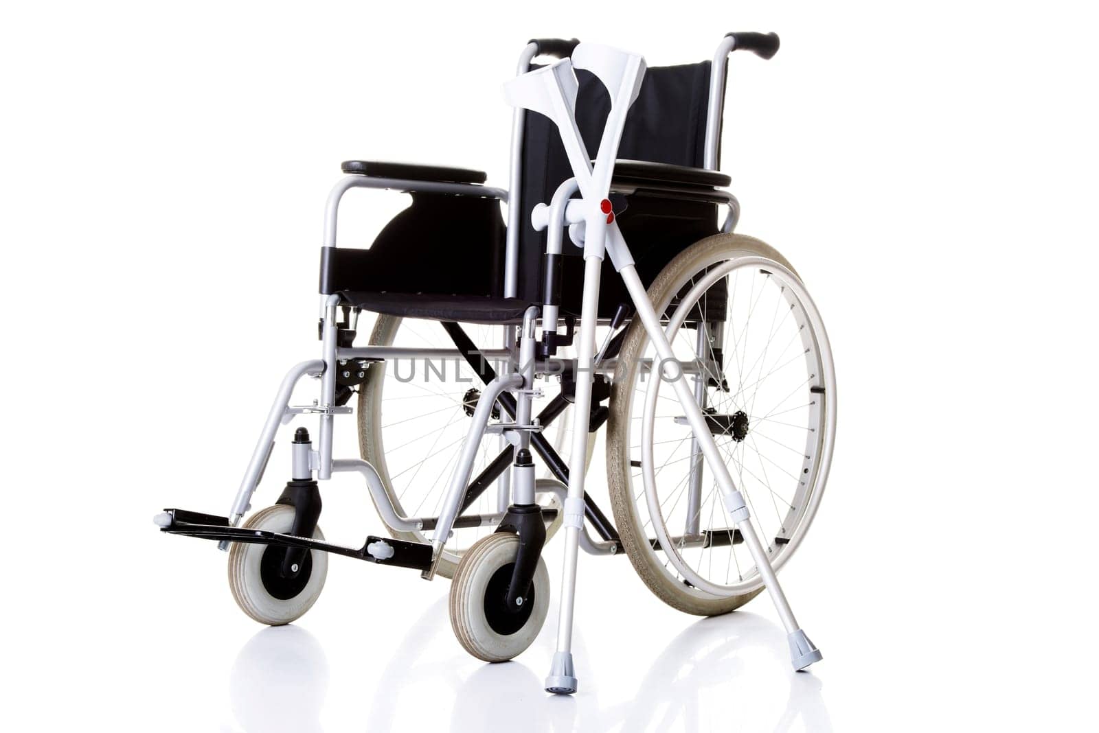 Invalid chair, wheelchair and crutches- isolated on white background