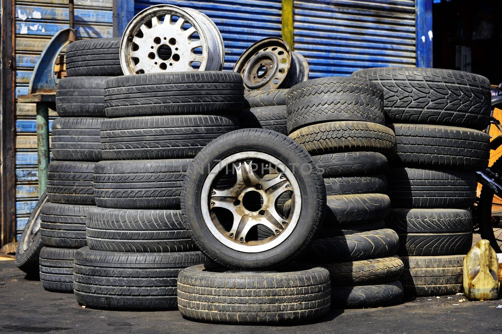 Stacks of old used tires in front of the auto service station