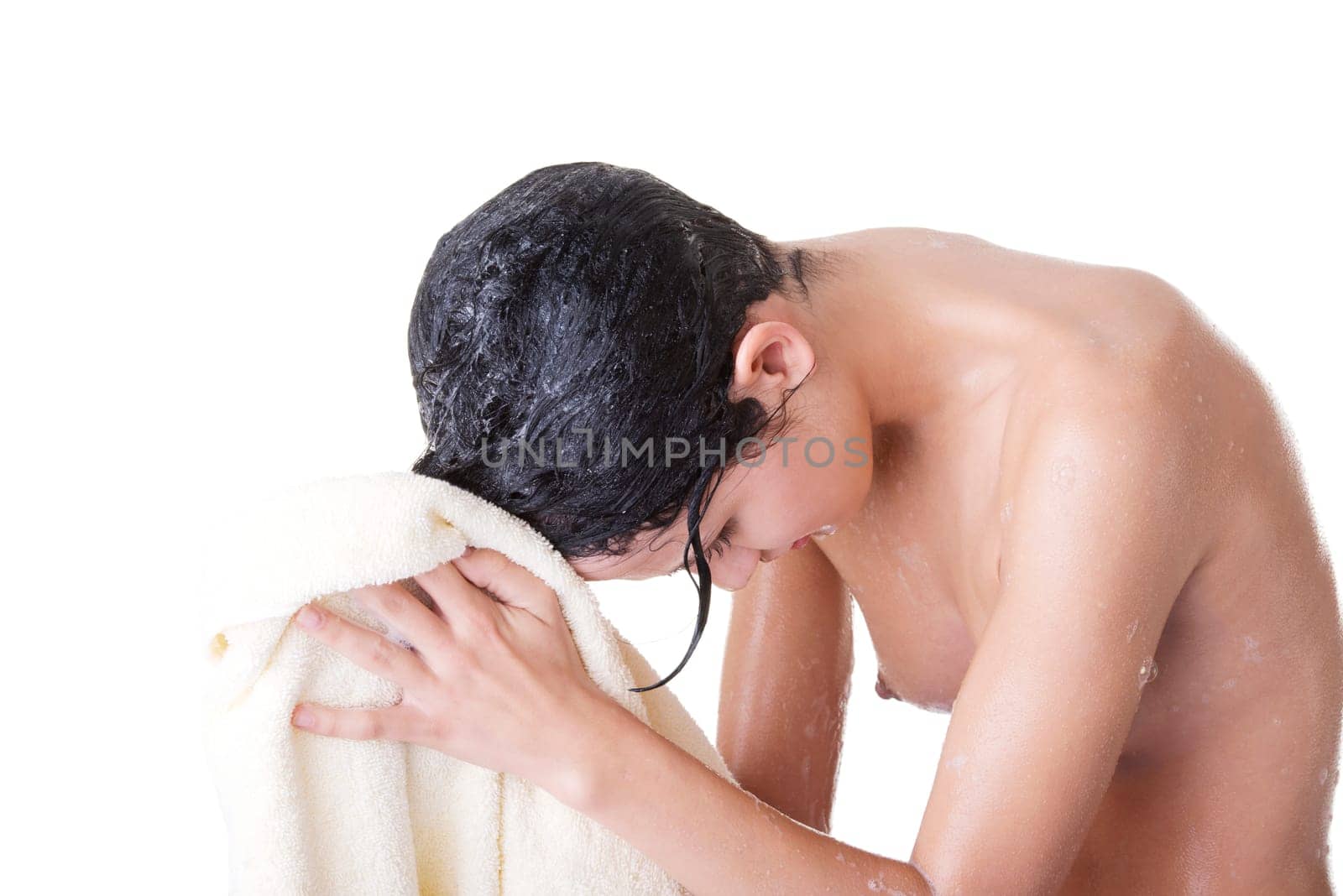 A young woman with wet hair in white robe toweling off after a shower.