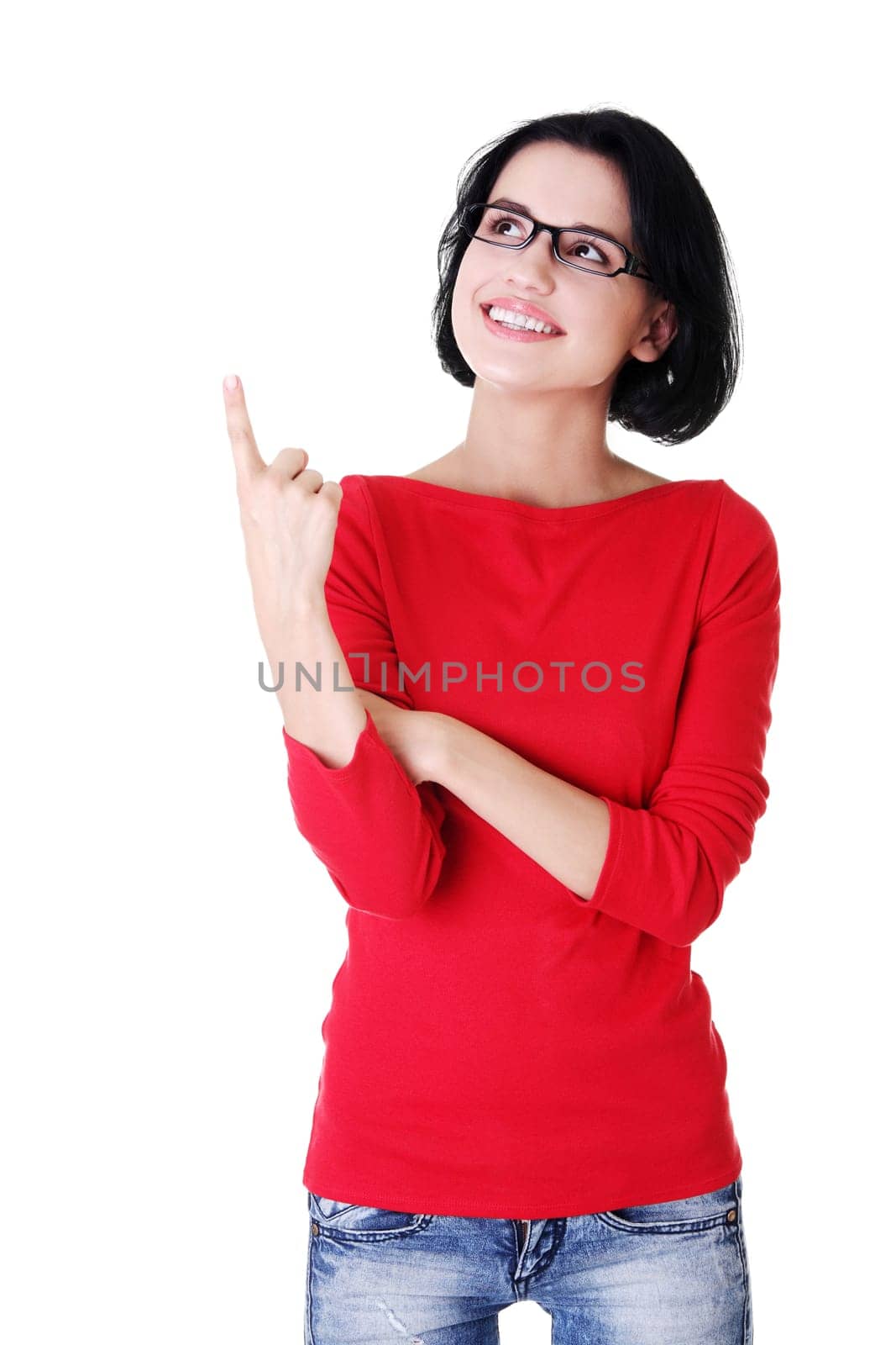 Happy , excited young woman pointing on copy space, isolated on white