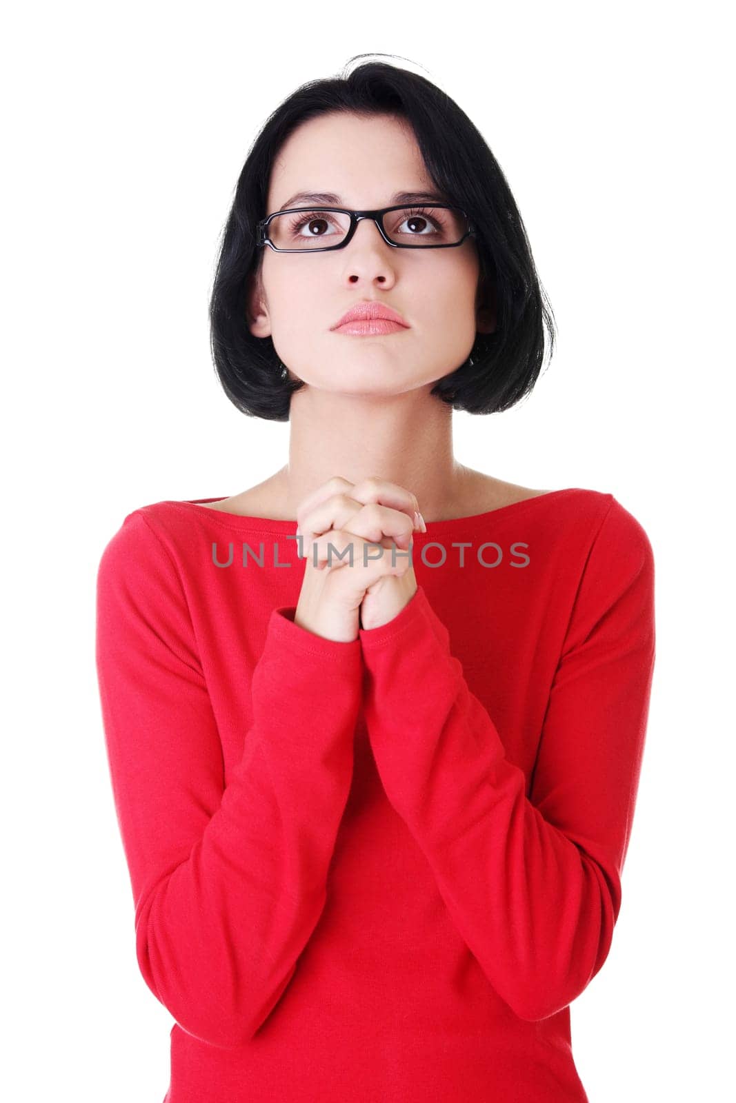 Young caucasian woman praying and looking up