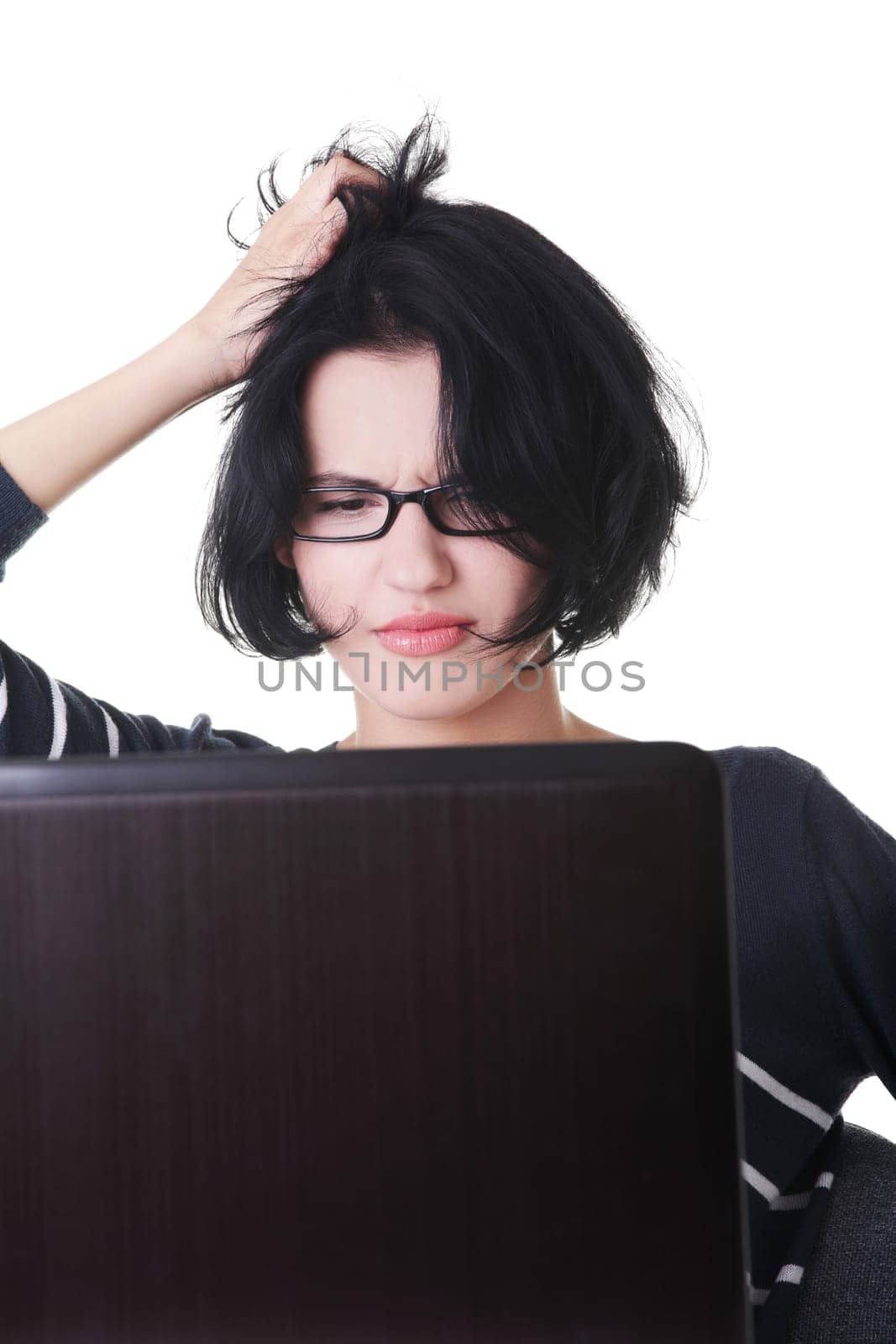 Frustrated woman working on laptop, isolated on white