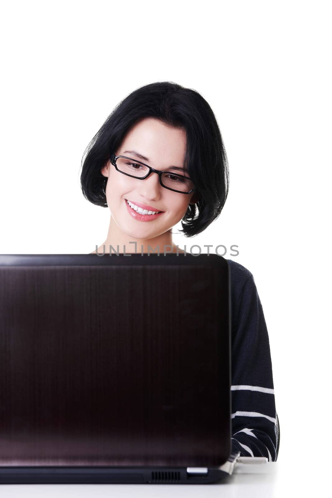 Happy young woman using her laptop, isolated on white.