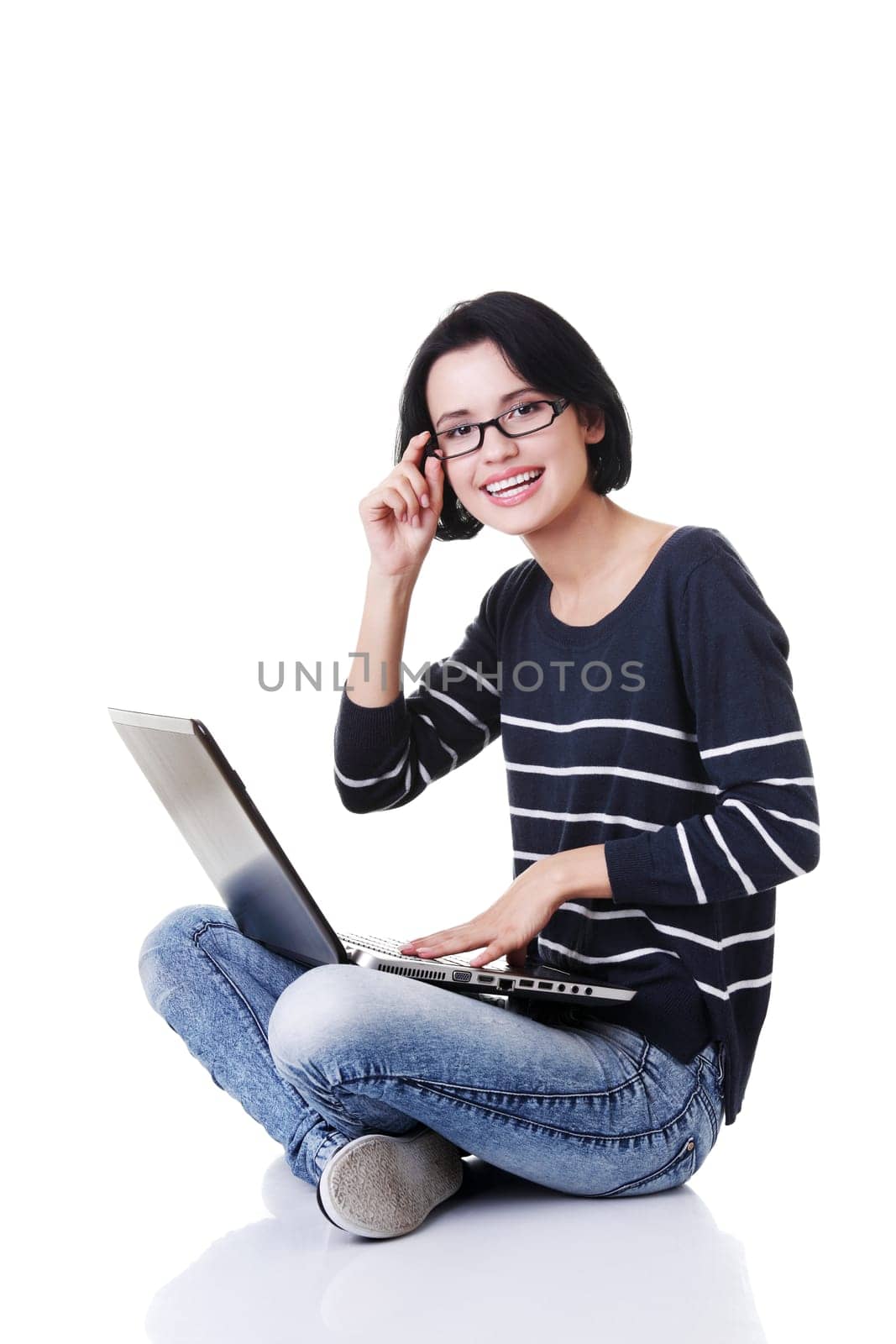 Happy young woman using her laptop, isolated on white.