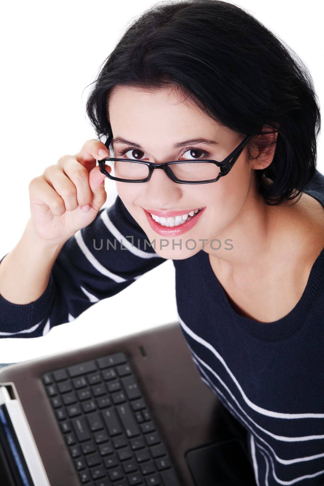 Happy young woman using her laptop, isolated on white.