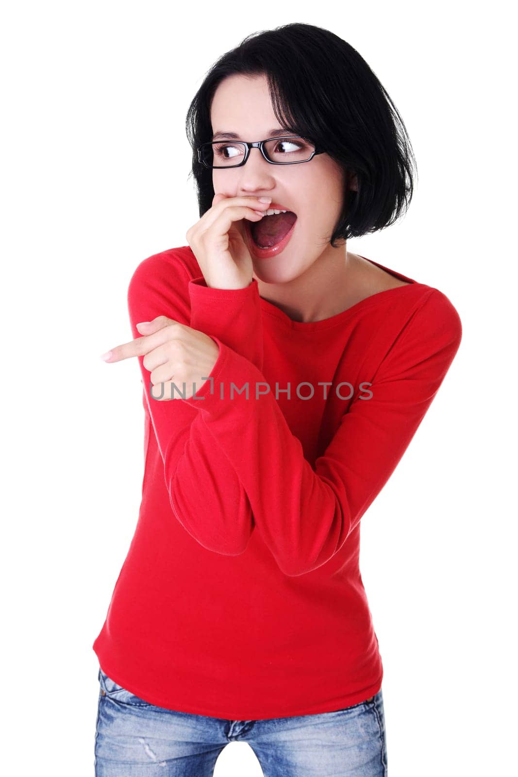 Happy , excited young woman pointing on copy space, isolated on white