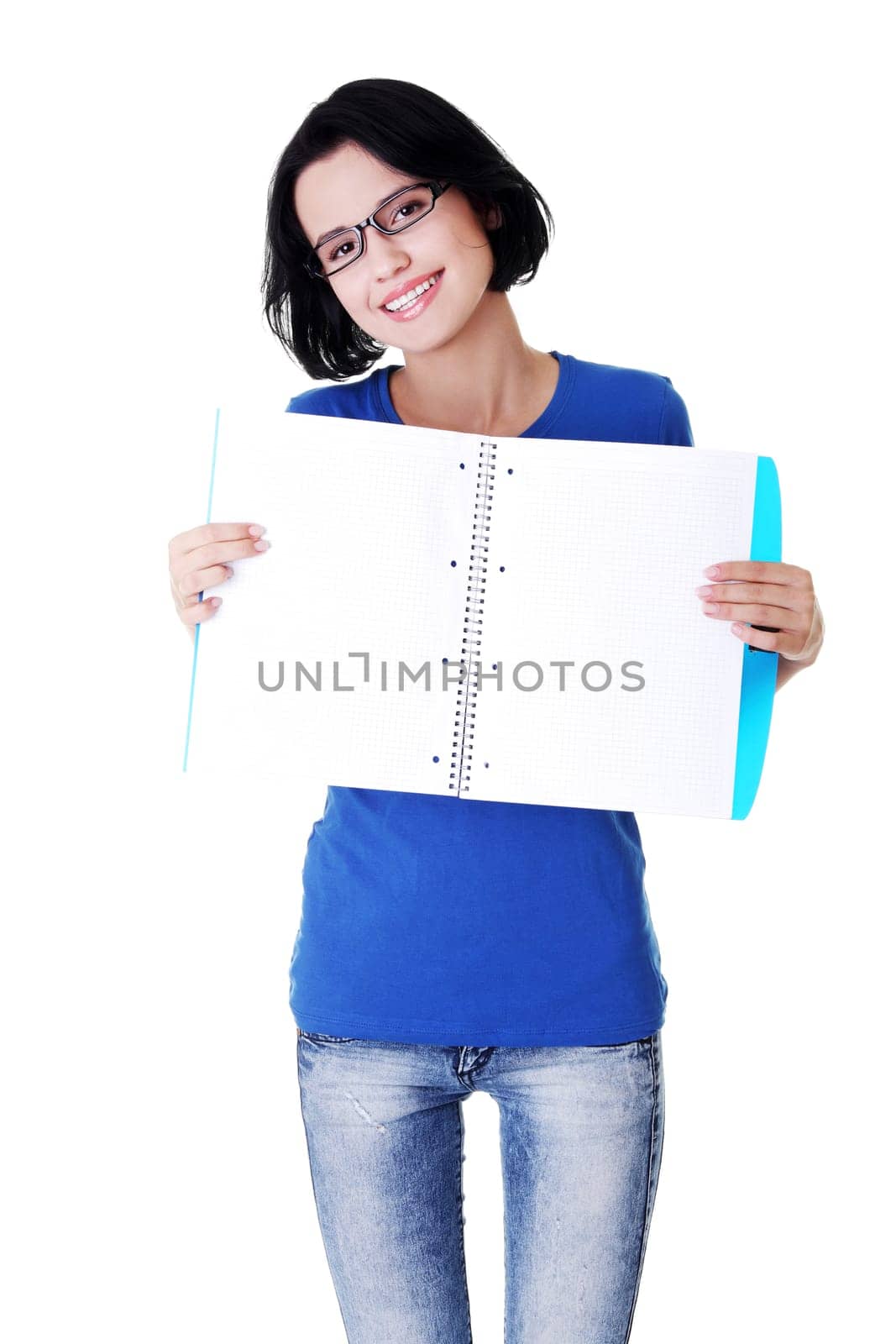 Studying happy young woman showing blank pages of her notebook for school.