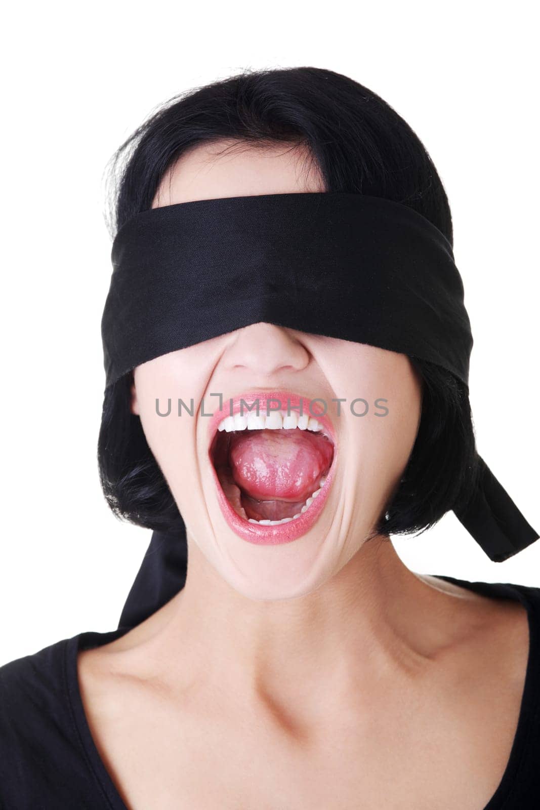 Portrait of a beautiful frighten young blindfold woman screaming