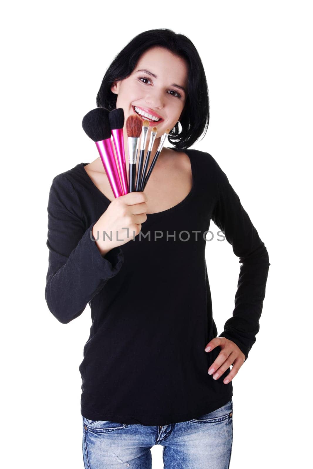 Young make-up artist woman holding brushes