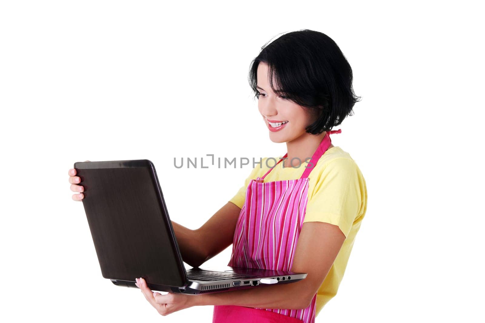Modern housewife or female worker with laptop wearing pink apron