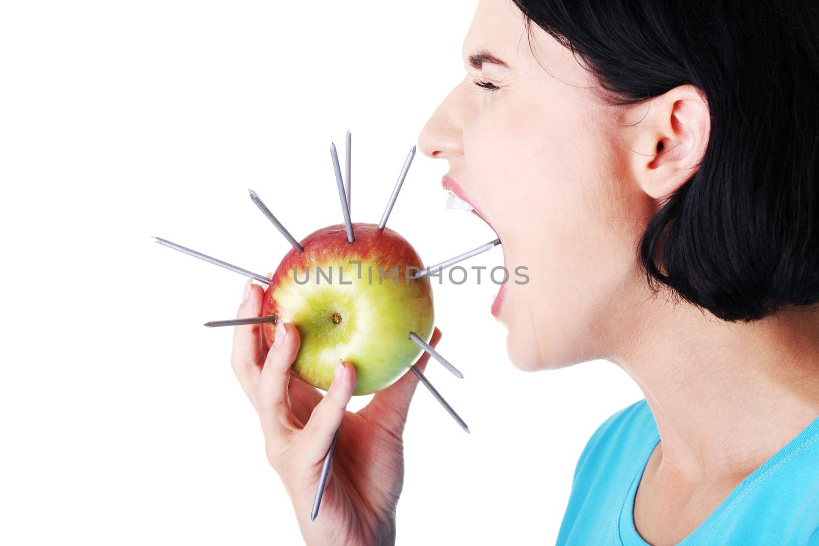 Throat pain concept. Woman eating apple with nails.