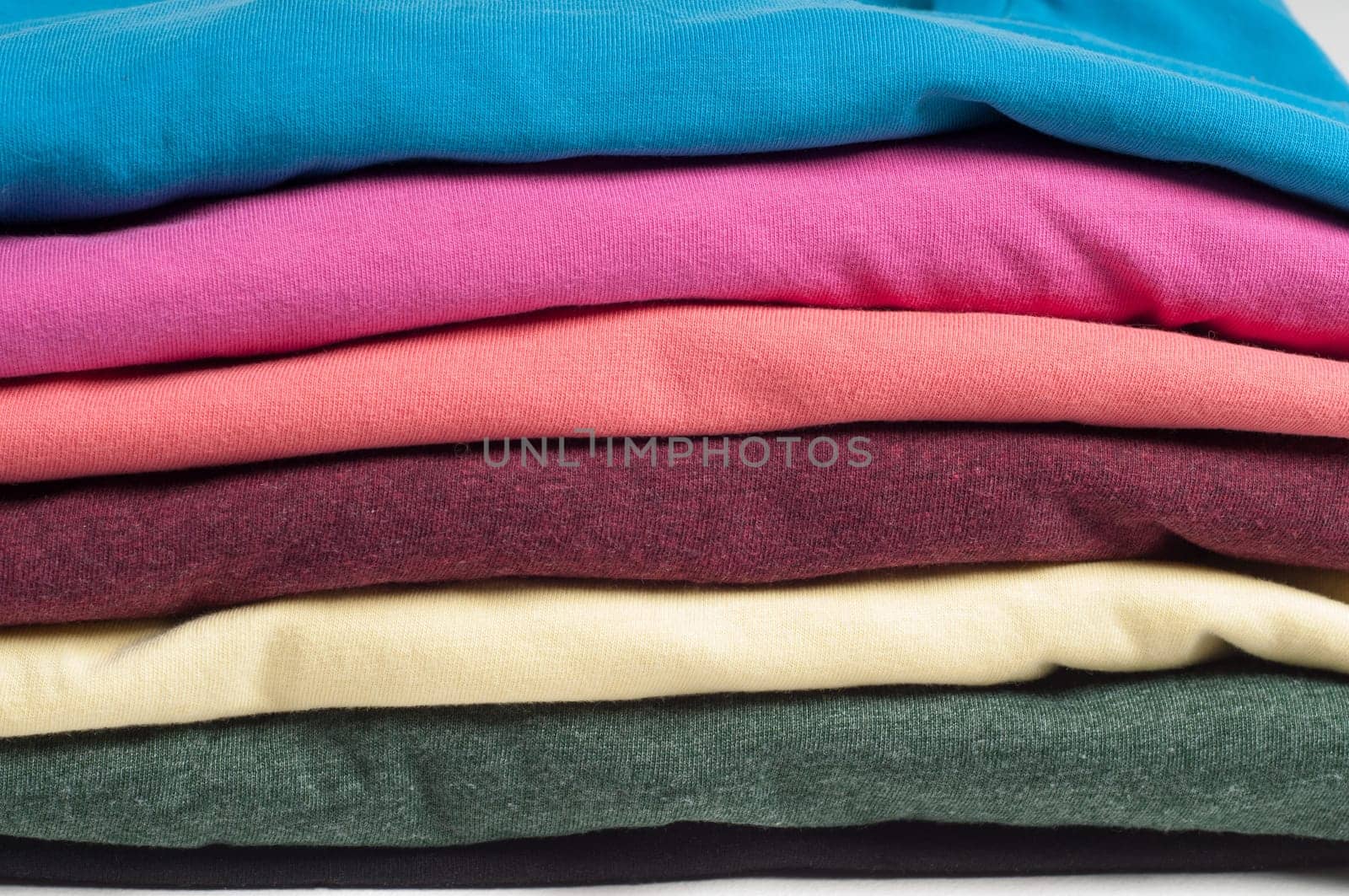 Multicolored clothes stacked